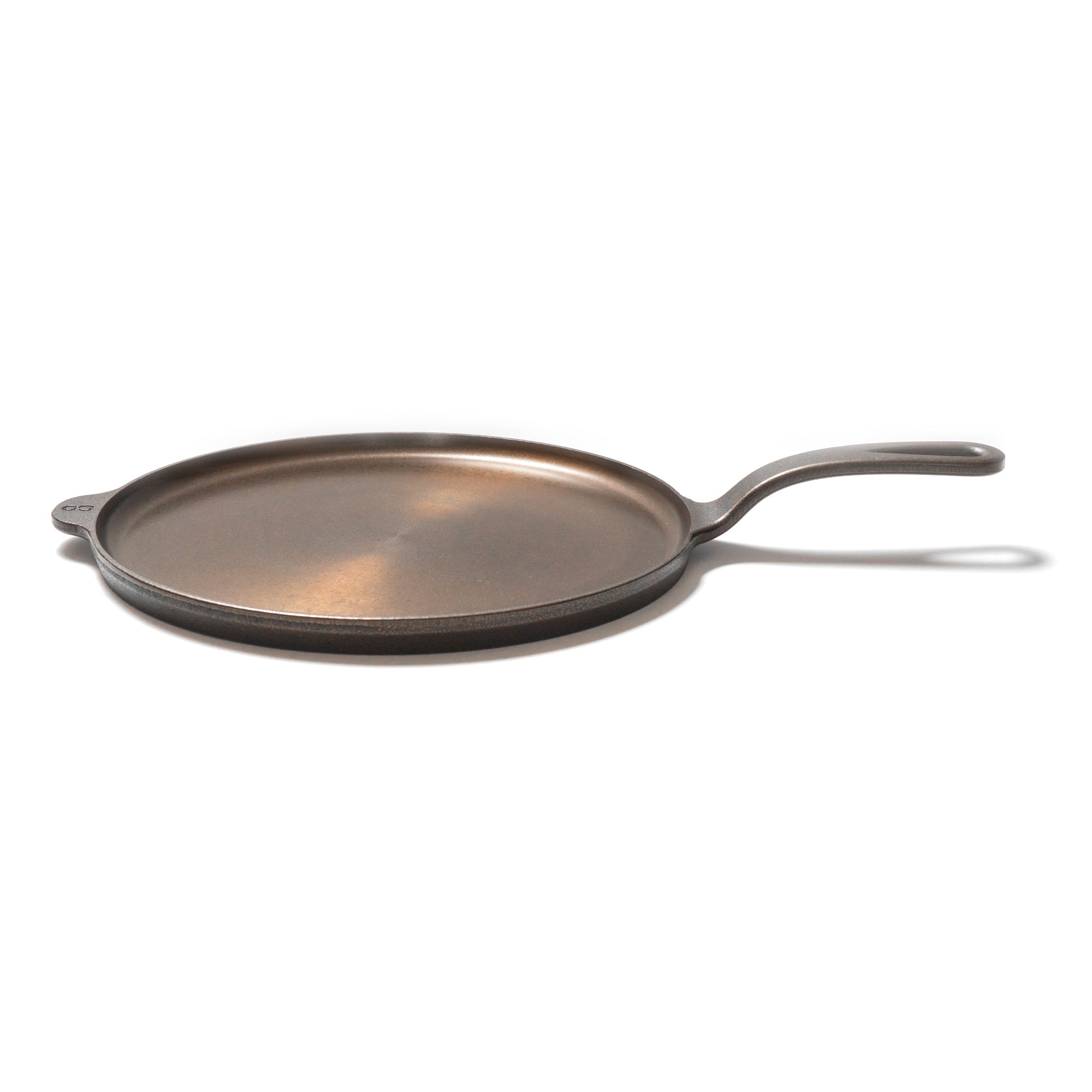 Cast iron griddle on a white background