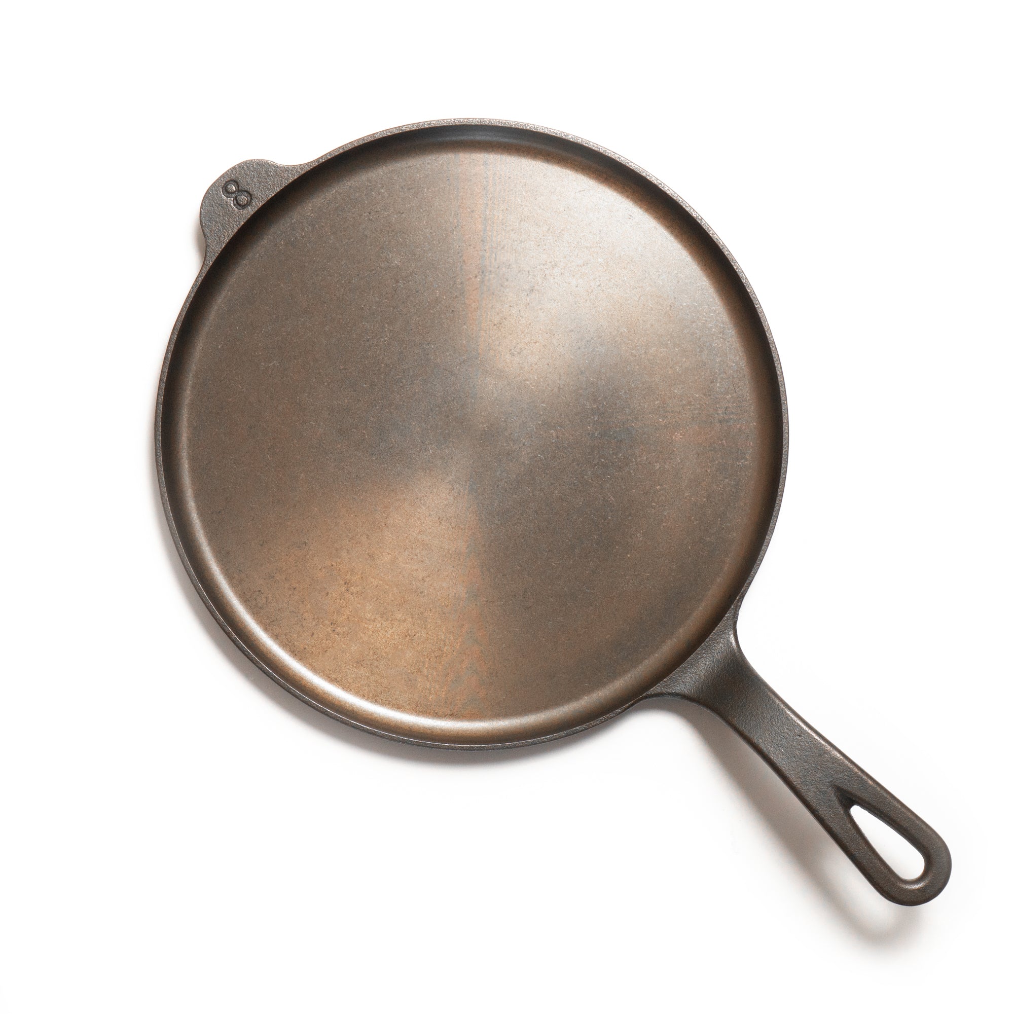 Cast iron griddle on a white background